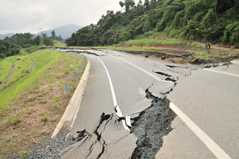 paved road with broken asphalt crack