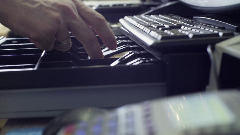 close up of a person's hands putting money in a cash box